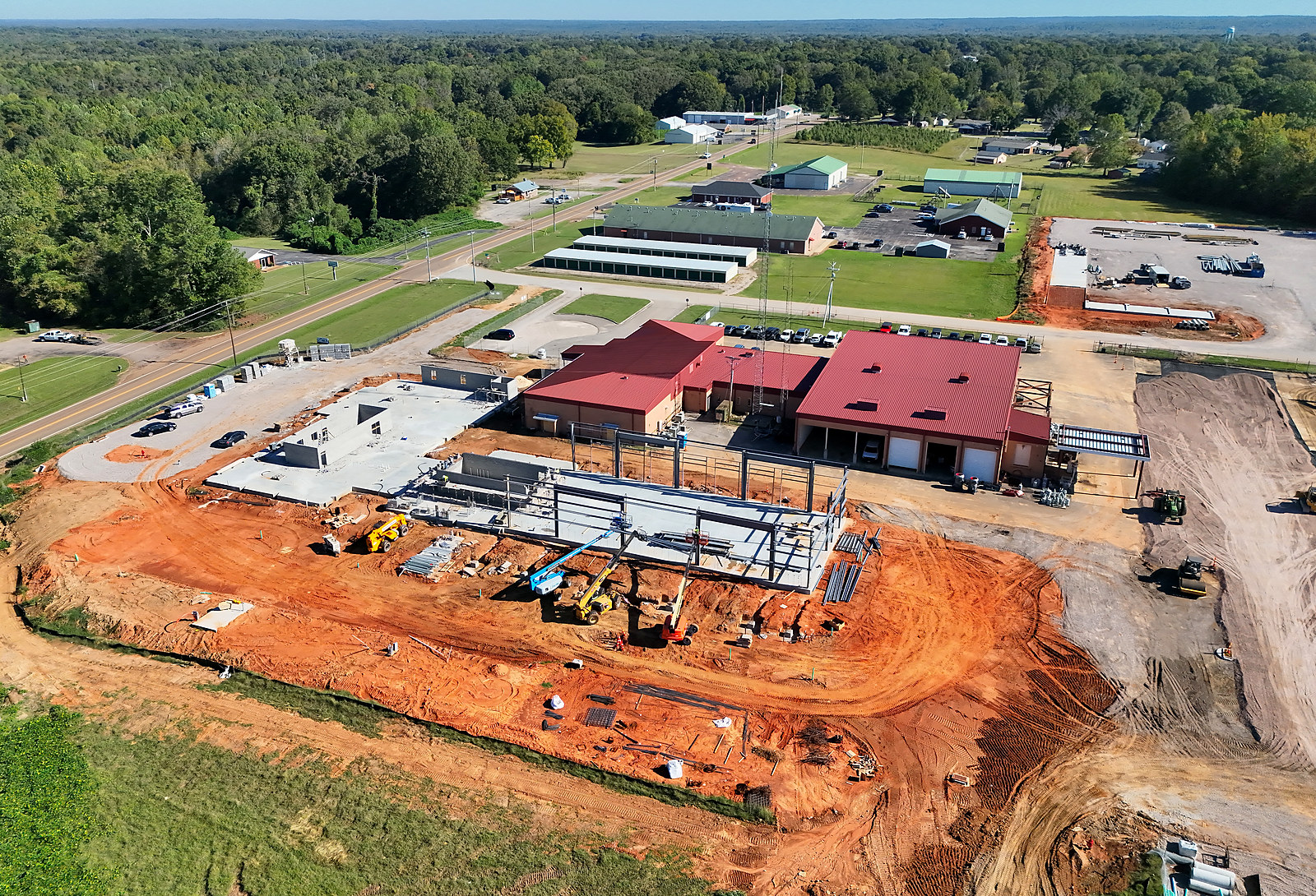 Aerial view of construction underway beside the red-roofed Bolivar Energy Authority service buildings